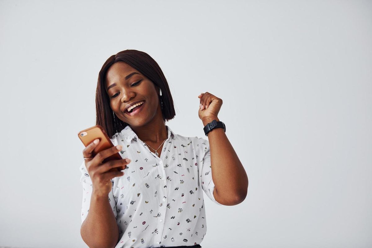 Woman celebrating a confirmed delivery on her phone